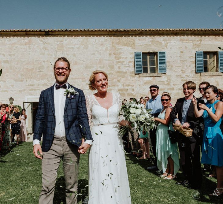 Confetti Moment with Bride in Rembo Styling Wedding Dress  and Groom  in Chino's and Checked Blazer