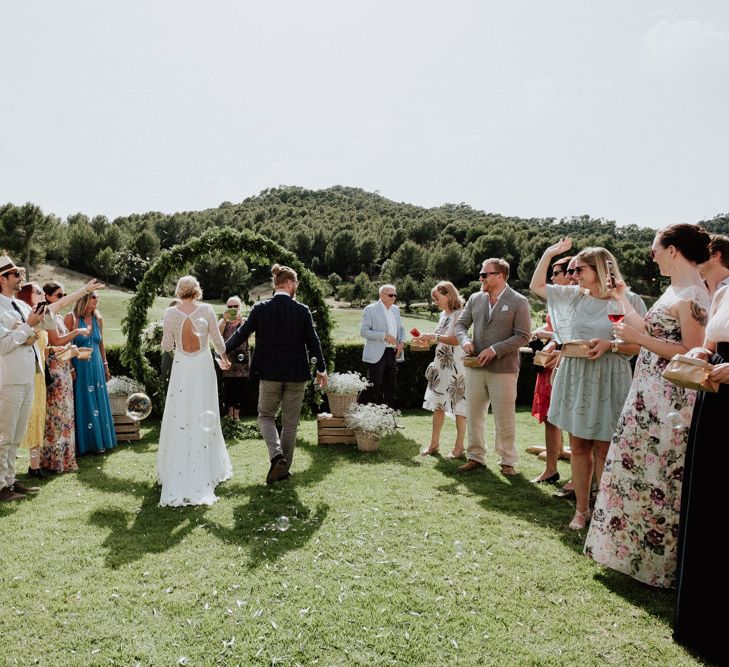 Confetti Moment with Bride in Rembo Styling Wedding Dress  and Groom  in Chino's and Checked Blazer