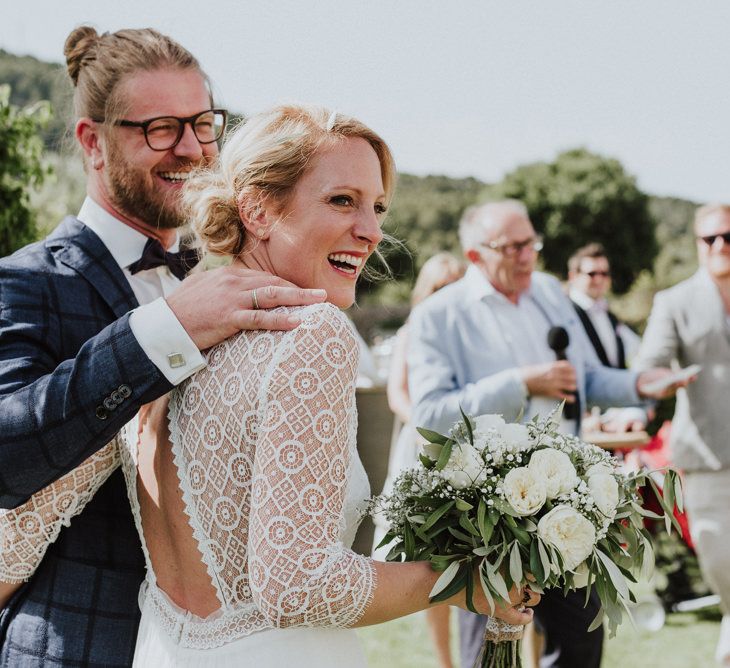 Bride in Rembo Styling Wedding Dress  and Groom  in Chino's and Checked Blazer Laughing