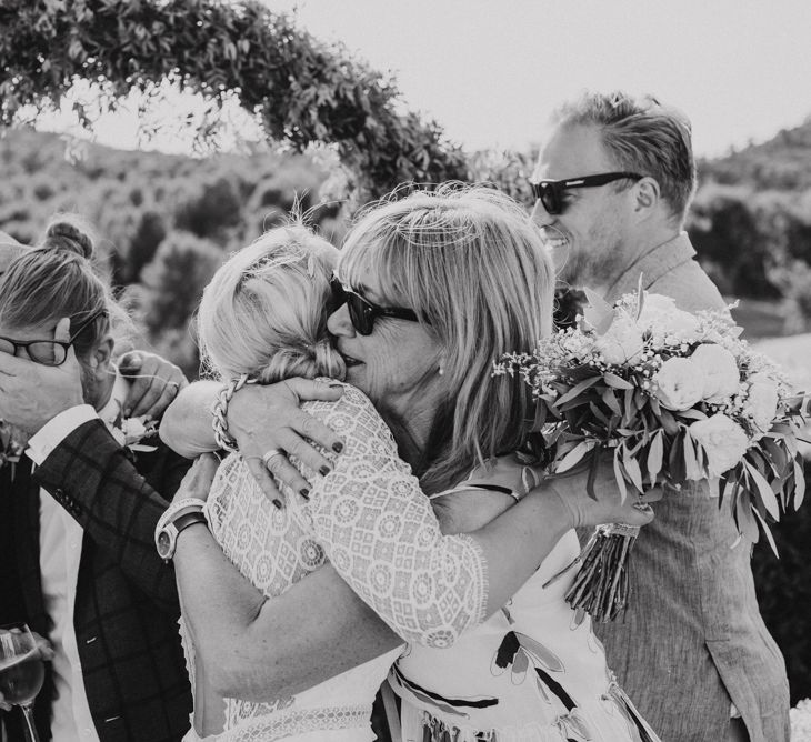 Bride and Grooms Hugging Their Wedding Guests