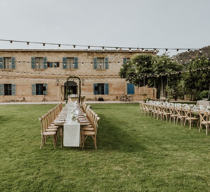 Outdoor Wedding Reception on Lawn of Destination wedding Venue with Festoon Lights