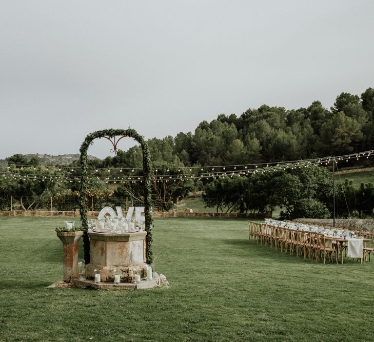 Sun Dial Wedding Feature with Foliage Arch and Candles