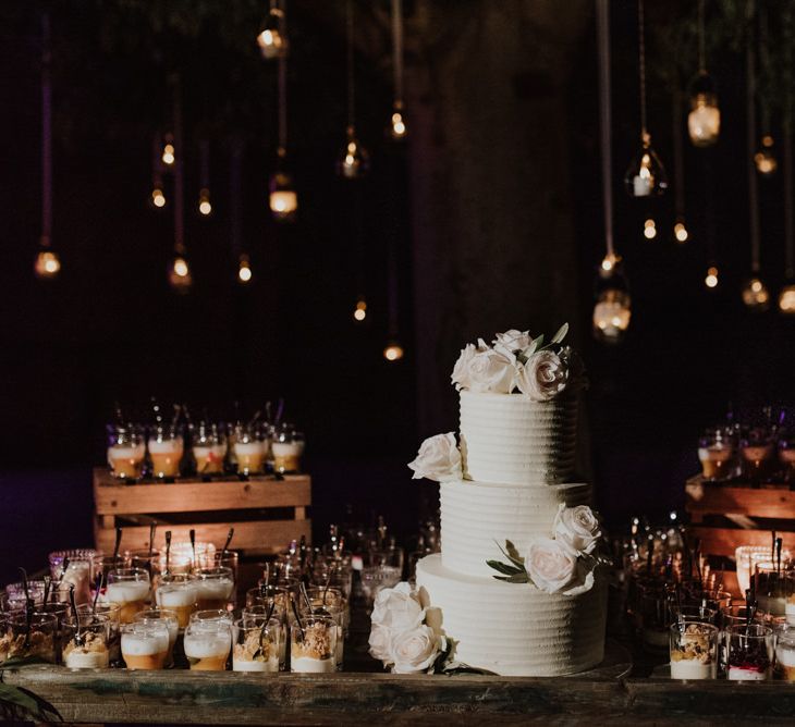 Dessert Table with White Wedding Cake and Individual Treats