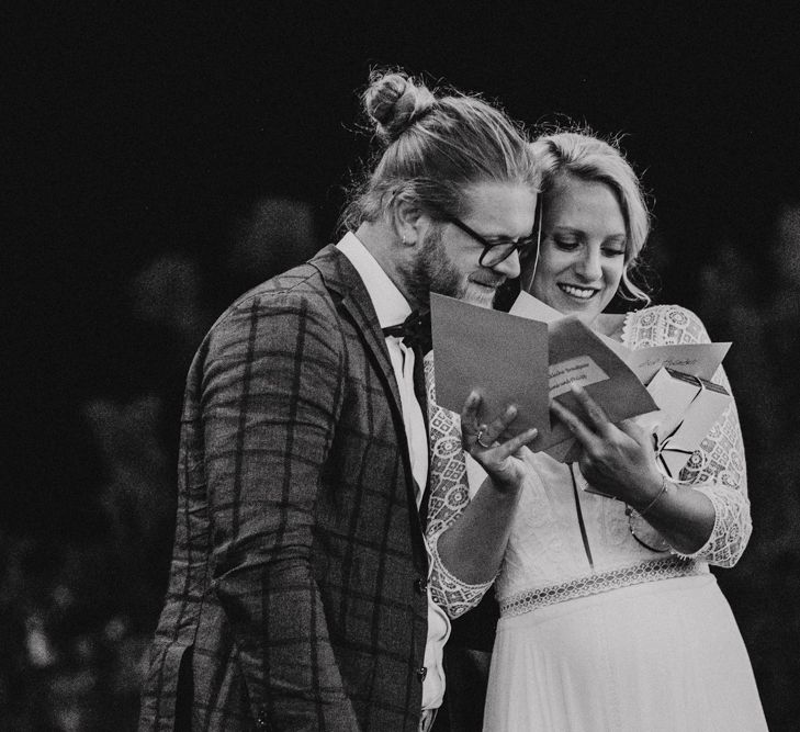 Bride and Groom Reading Wedding Cards During The Reception