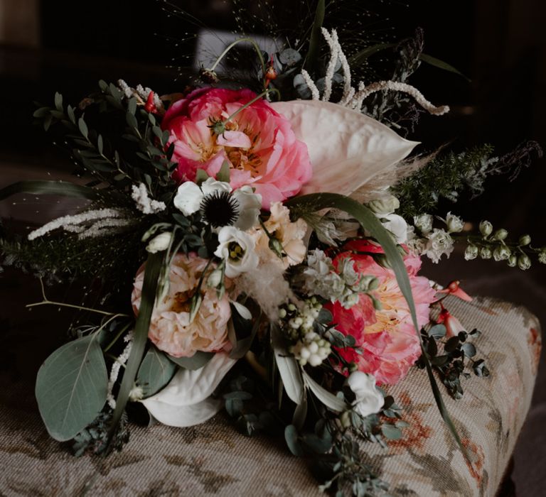 Wedding bouquet with coral peonies and foliage