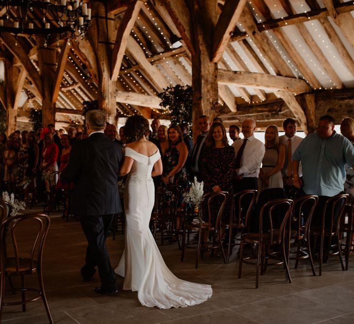 Bride walking down the aisle of Tithe Barn Bolton Abbey wedding ceremony