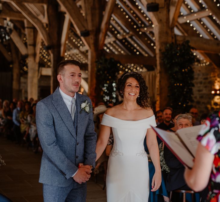 Bride and groom holding hands at Tithe Barn Bolton Abbey wedding ceremony