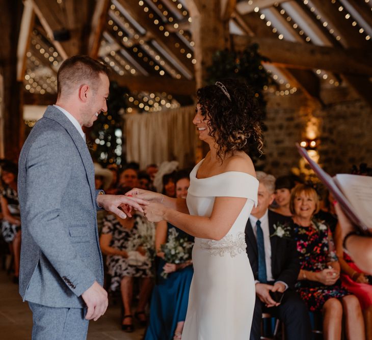 Bride and groom exchanging rings at Tithe Barn Bolton Abbey wedding