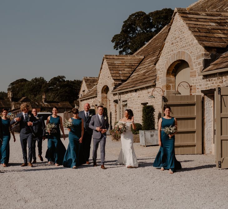 Wedding party portrait with bridesmaids in teal dresses