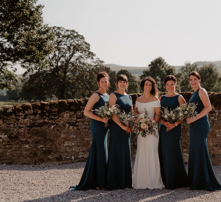 Bridal party portrait at Tithe Barn Bolton Abbey with bridesmaids in teal dresses