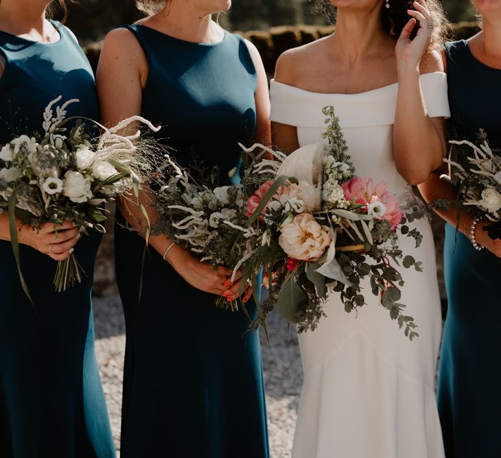 Bridal party wedding bouquets with peonies and foliage