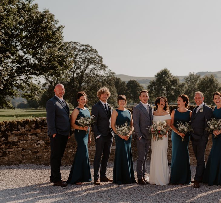 Wedding party portrait with bridesmaids in teal dresses