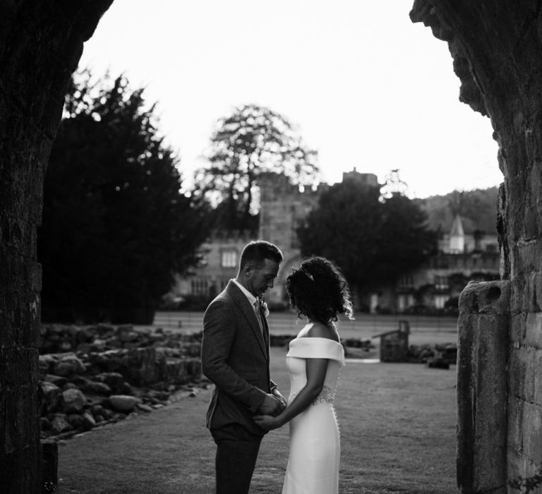 Black and white portrait of bride in Suzanne Neville wedding dress