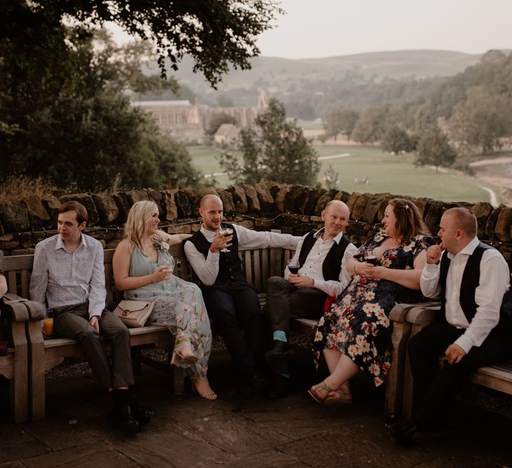 Wedding guests sitting outside