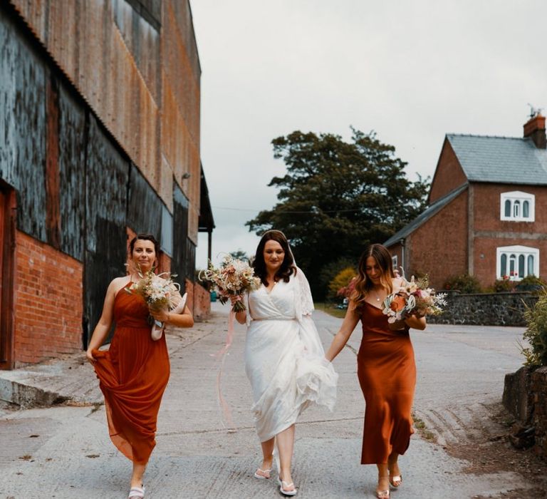 Bride with bridesmaid in Autumn wedding colours dresses