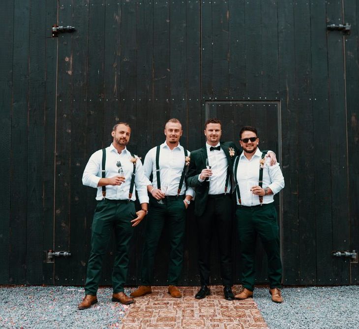 Groom with groomsmen in matching suits