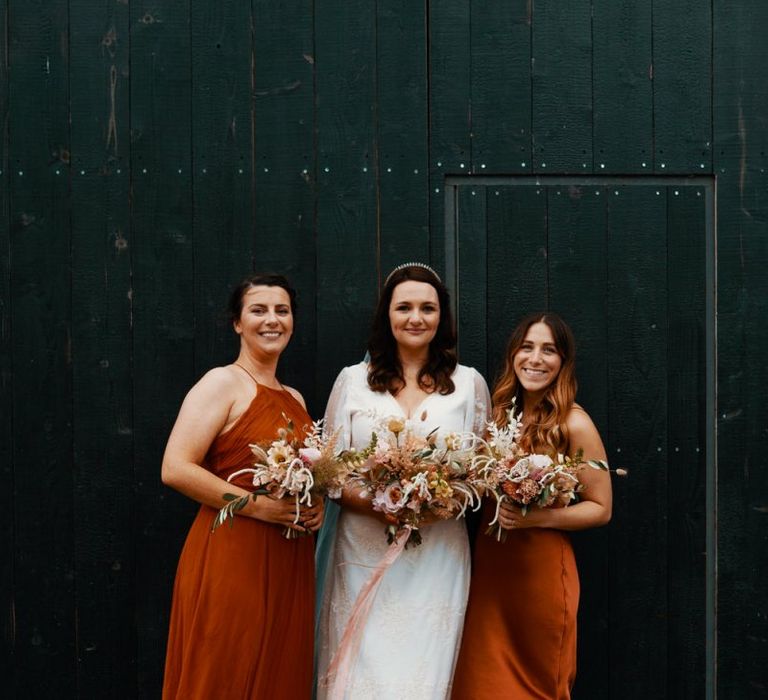 Bride with bridesmaids in Autumn wedding colours dresses