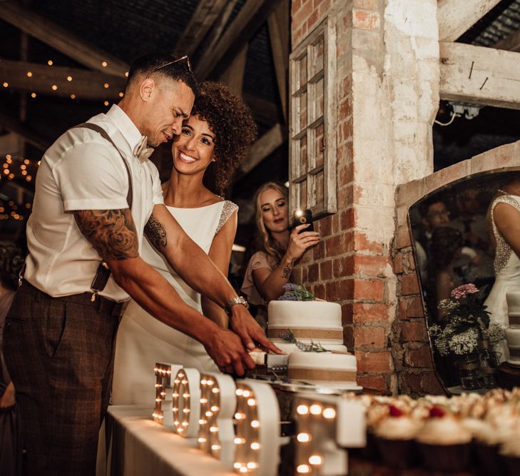 Cutting The Cake // Caribbean Influenced Wedding Kingsthorpe Lodge Barn With Steel Band And Bride In Maggie Sottero Images From Ania Ames Photography