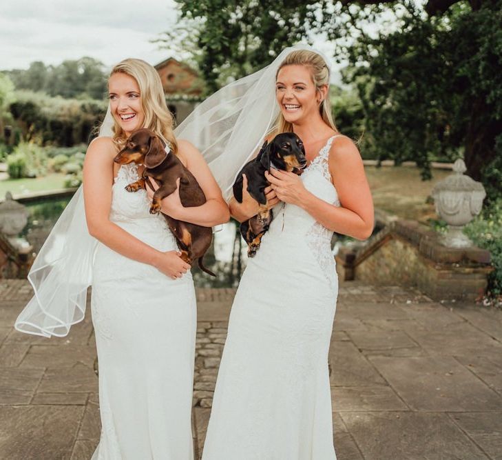 Couple with their pet dachshunds in bow ties