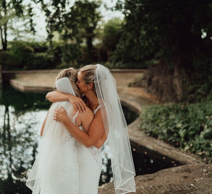 Bride and bride embrace at Micklefield Hall wedding