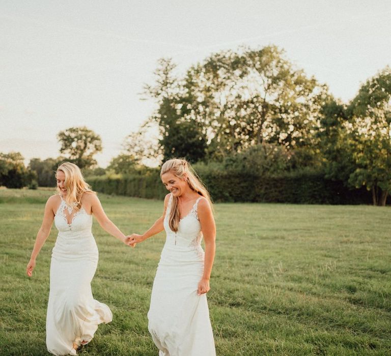 Same-sex wedding with both brides in lace wedding dresses