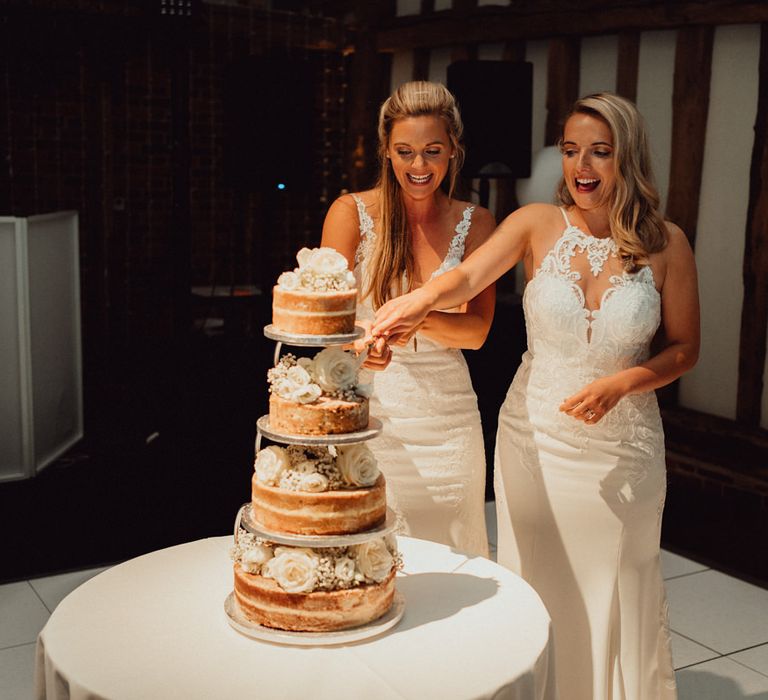 Brides cut the naked wedding cake