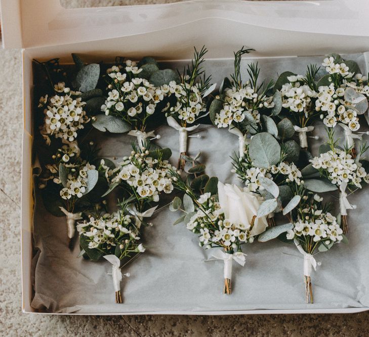 White floral buttonholes at Farbridge wedding venue