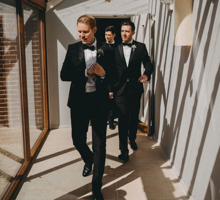 Groom and groomsmen in classic black tuxedos