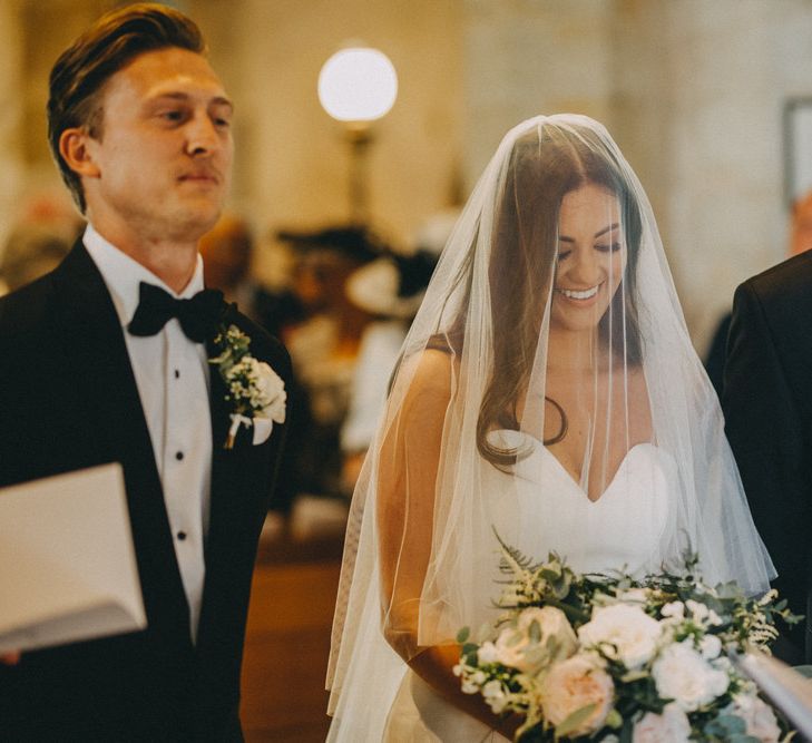 Bride greets groom at altar with veil over face