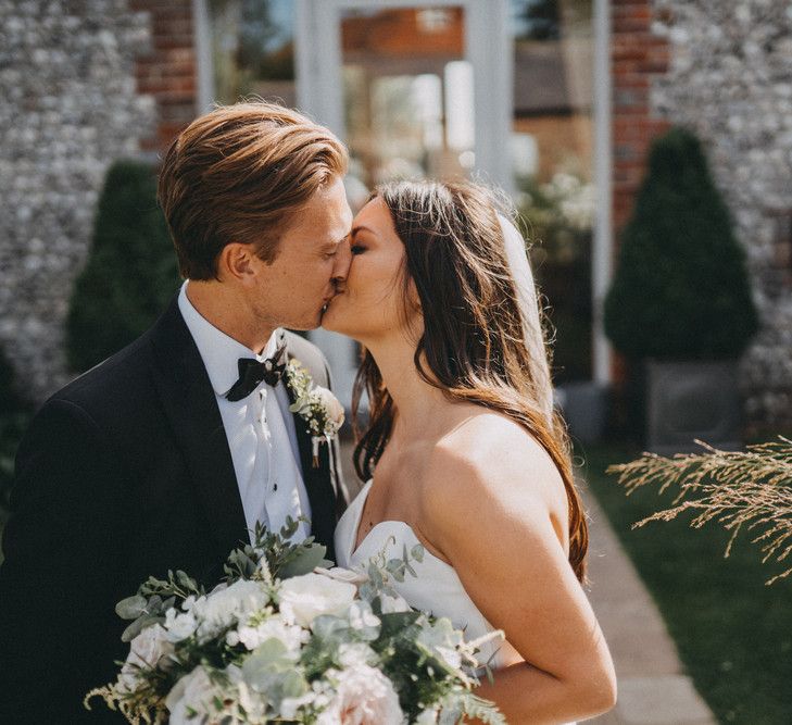 Bride and groom kiss at Farbridge wedding venue