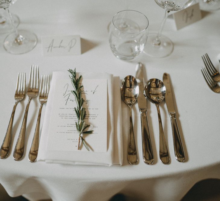 Wedding table place setting with herb decor