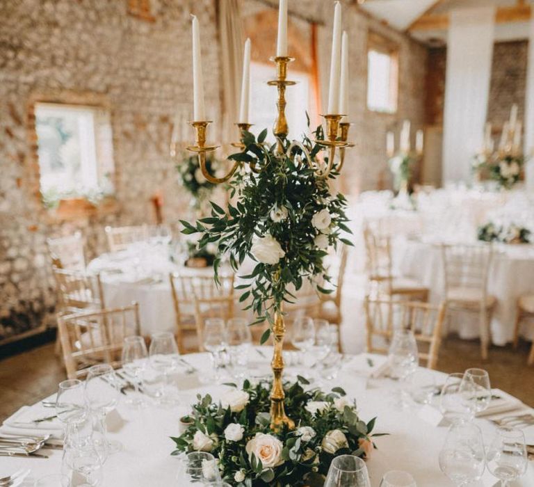 Tall floral wedding centrepiece with candelabra