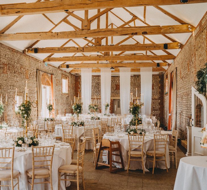 Farbridge wedding venue with tall centrepieces on table of rustic barn