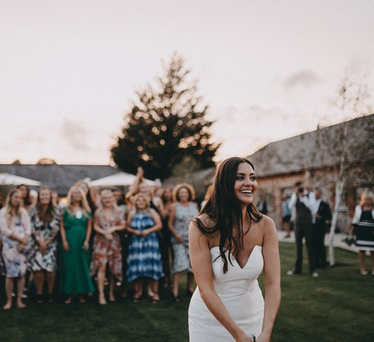 Bride gets ready to throw her bouquet to guests