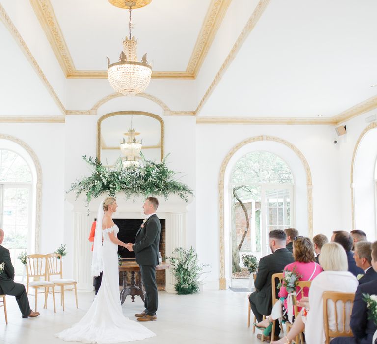 Wedding Ceremony with Bride in Lace St Patrick Wedding Dress and Groom in Grey Empire Outlet Suit