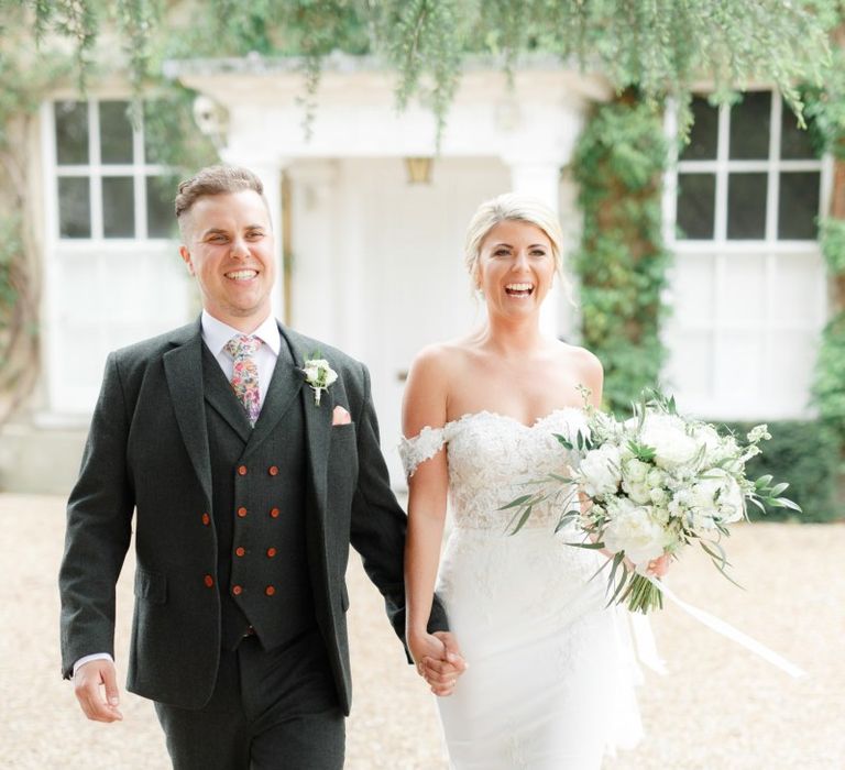 Bride in Off the Shoulder St Patrick Wedding Dress and Groom in Three Piece Suit