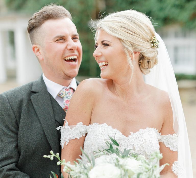 Groom Embracing His Bride in a Sweetheart Neckline Wedding Dress