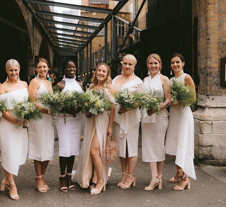 Bride in Bespoke Wedding Gown with Blush Underskirt and One Off Shoulder Strap | Nude Topshop Shoes with Pom Pom | Bridesmaids in Mismatched White Dresses | Homemade Bouquets of White Flowers, Ferns and Foliage | Bike Shed Motorcycle Club Wedding for ELLE Digital Editor | Nigel John Photography