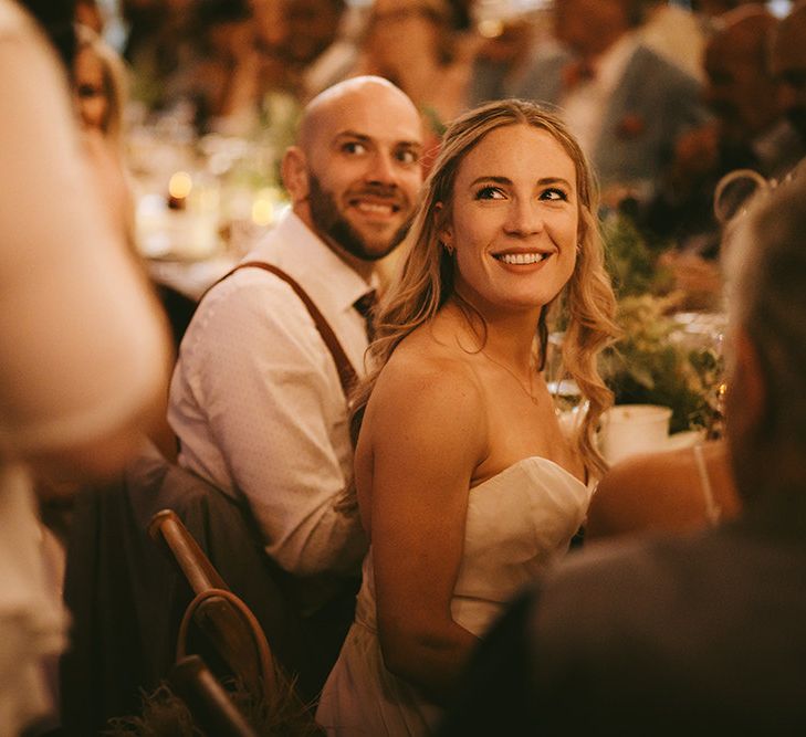 Wedding Reception Speeches | Bride in Bespoke Wedding Gown with Blush Underskirt and One Off Shoulder Strap | Half Up Half Down Bridal Hair | Groom in Grey Puppy Tooth Check Two-Piece Paul Smith Suit with Amber Tie Pin, Pocket Square and Braces | Bike Shed Motorcycle Club Wedding for ELLE Digital Editor | Nigel John Photography