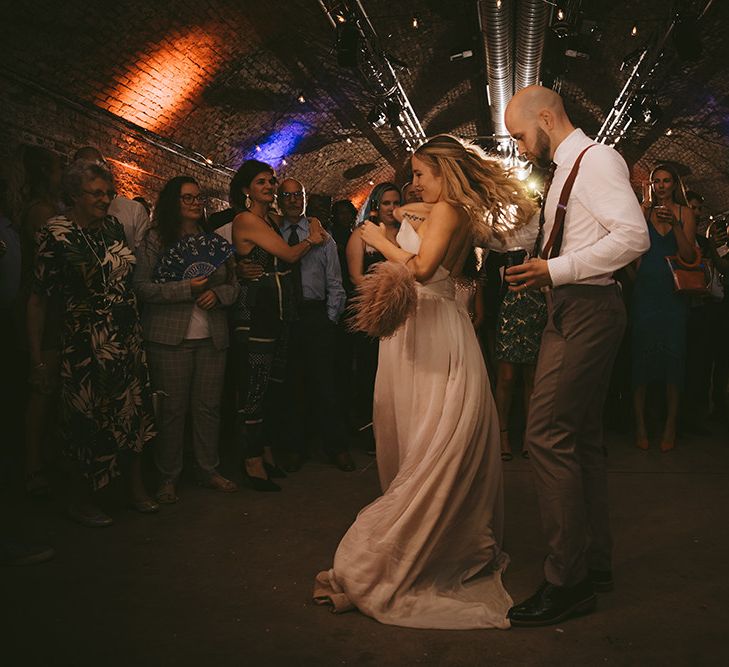 First Dance | Bride in Bespoke Wedding Gown with Blush Underskirt and One Off Shoulder Strap | Half Up Half Down Bridal Hair | Groom in Grey Puppy Tooth Check Two-Piece Paul Smith Suit with Amber Tie Pin, Pocket Square and Braces | Bike Shed Motorcycle Club Wedding for ELLE Digital Editor | Nigel John Photography