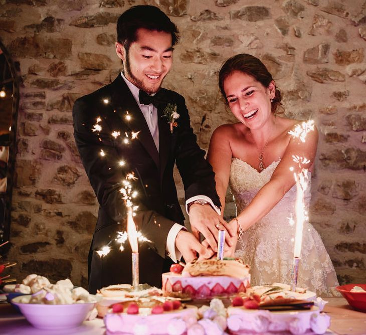 Bride &amp; Groom Cutting The Cake | Colourful Chinese Lanterns at Domaine St Germain Wedding Venue, South of France | Andy Gaines Photography | Thompson Granger Films