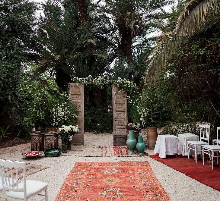 Wooden Door Altar | Moroccan Rugs | Outdoor Ceremony Wedding Decor | Paradise Destination Wedding at Jnane Tamsna in Marrakech, Morocco | Nordica Photography | Matteo Castelluccia Film