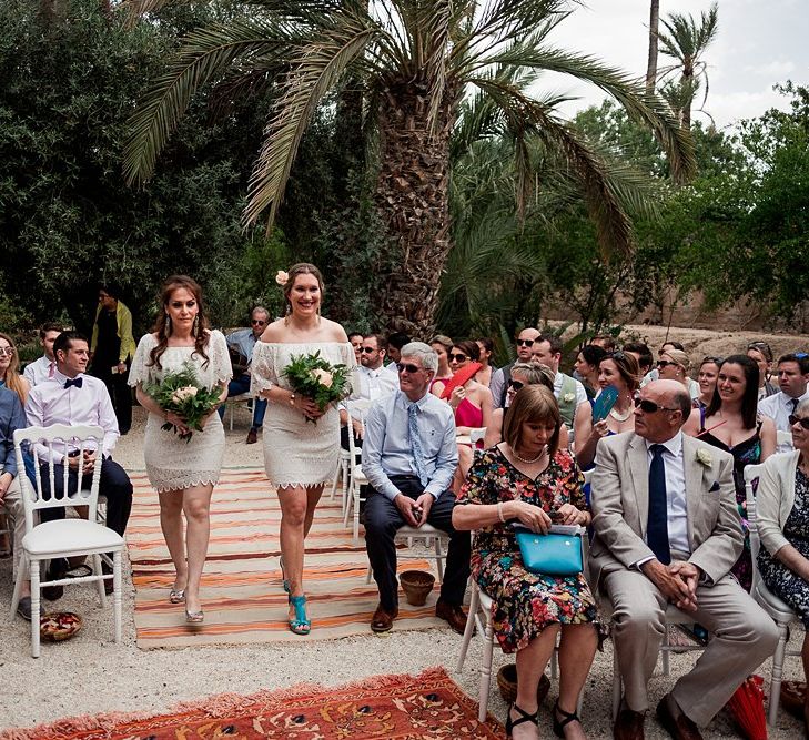 Outdoor Wedding Ceremony | Moroccan Rugs | Bridesmaids in White Vero Moda Dresses |  Paradise Destination Wedding at Jnane Tamsna in Marrakech, Morocco | Nordica Photography | Matteo Castelluccia Film