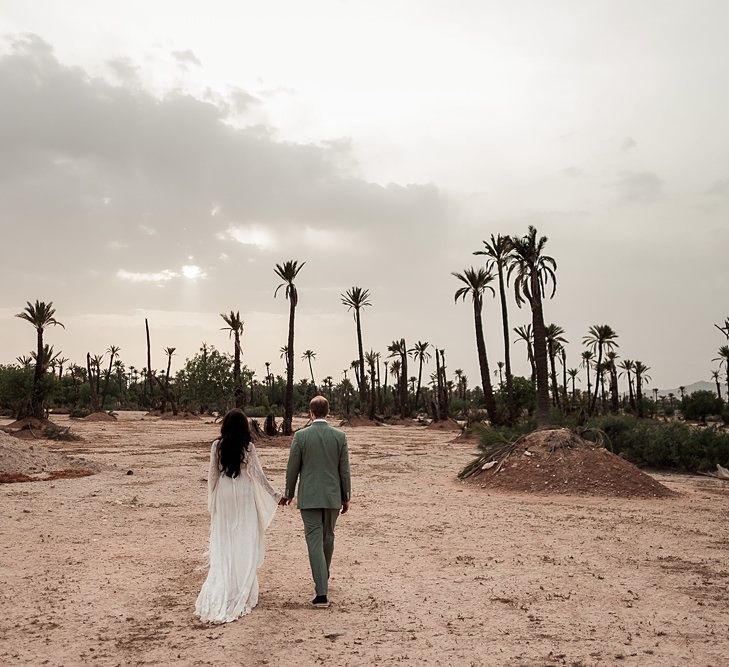 Bride in rue de Seine Bridal Gown | Groom in Green Beggars Run Suit | Paradise Destination Wedding at Jnane Tamsna in Marrakech, Morocco | Nordica Photography | Matteo Castelluccia Film