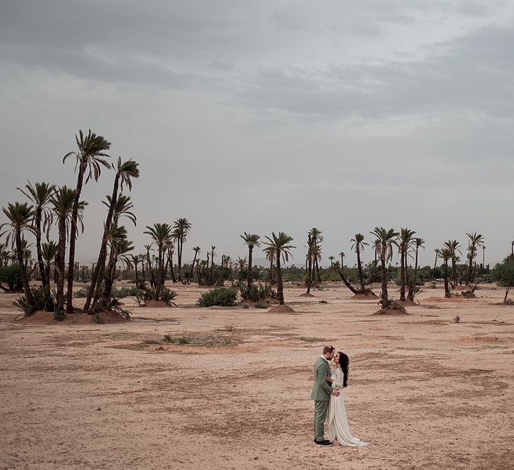 Bride in rue de Seine Bridal Gown | Groom in Green Beggars Run Suit | Paradise Destination Wedding at Jnane Tamsna in Marrakech, Morocco | Nordica Photography | Matteo Castelluccia Film