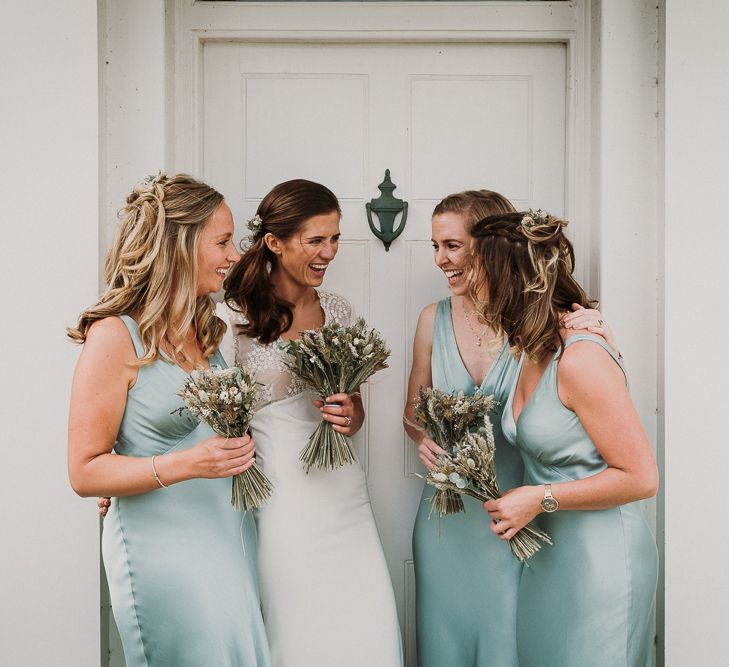 Bridal Party in pale green Ghost bridesmaid dresses and Pre-owned Rime Arodaky wedding dress