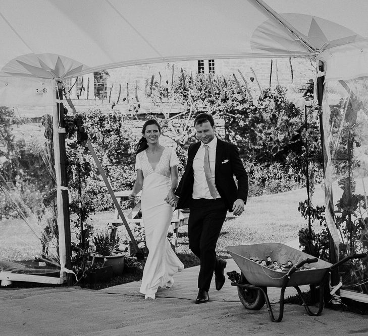 Bride and groom entering the stretch tent wedding reception