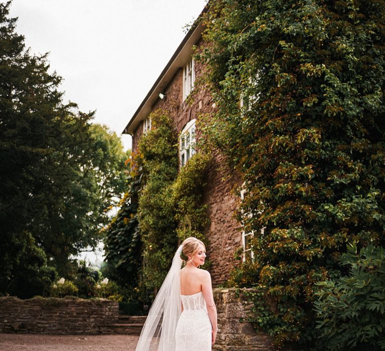 Back of brides strapless gown with beaded detailing at Dewsall Court wedding