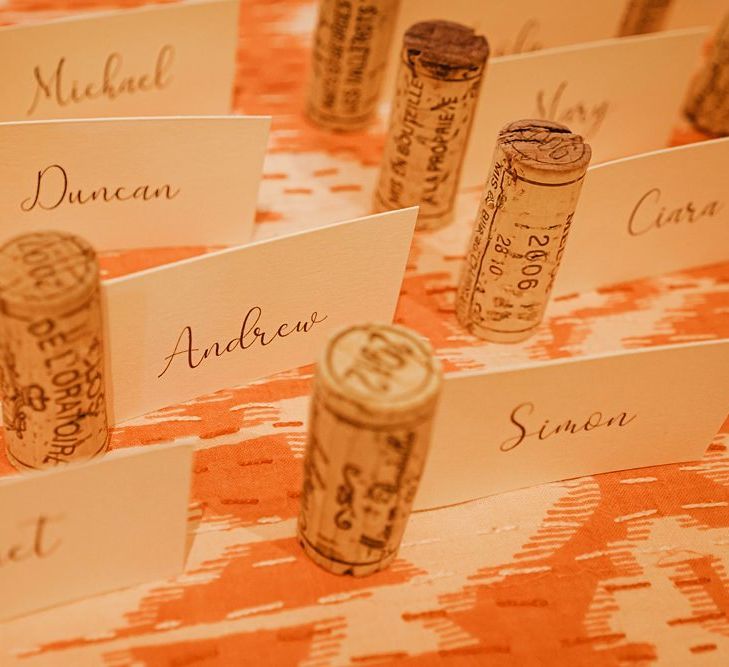 Personalised table setting cards using wine corks for barn reception