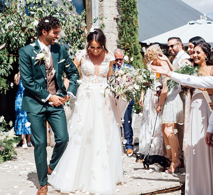 Confetti Moment | Bride in Antonia Berta Muse Wedding Dress | Groom in Navy Suit | Rustic Greenery Wedding at Cripps Barn Cotswolds | Wedding_M Photography